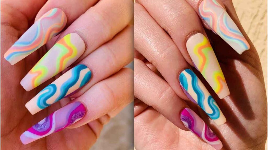 Vibrant multicolor wavy abstract nail art on long manicured nails.