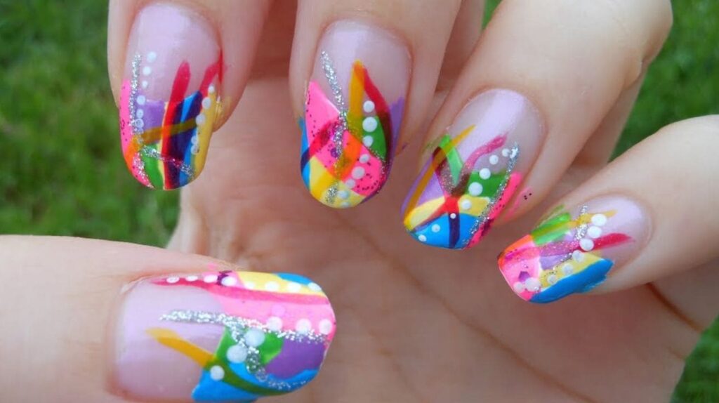 Colorful abstract nail art with paint strokes and dot patterns on short nails